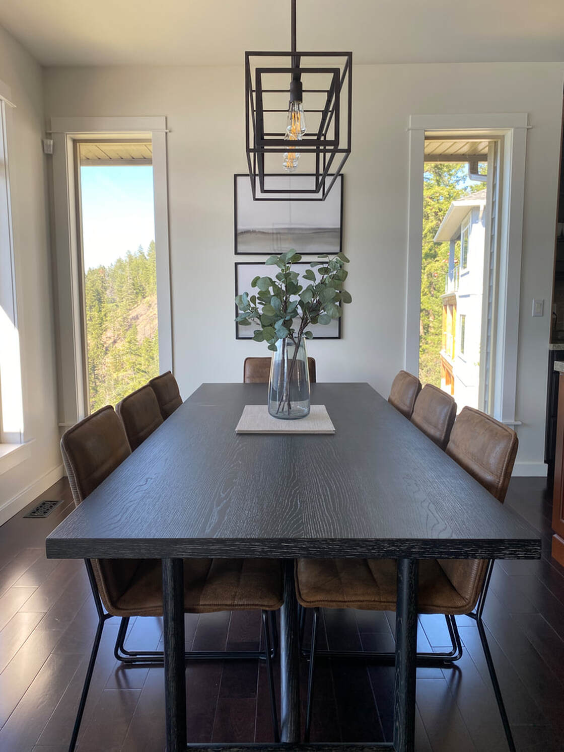Modern dining room, leather dining chairs, black wood dining table, dining centerpiece, lake view, Vernon BC interior design, interior designer, Alyssa Wilcox Interiors
