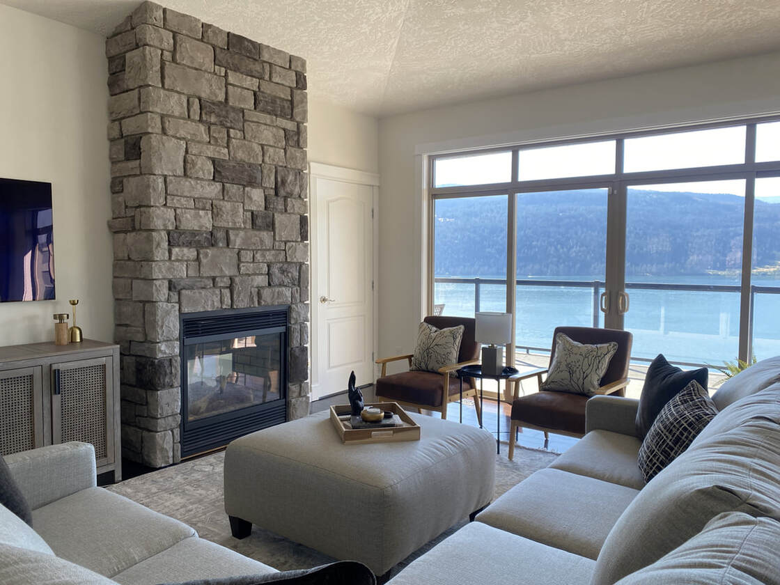 Living room décor, stone fireplace, sectional, lake house, Vernon BC interior design, interior designer, Alyssa Wilcox Interiors